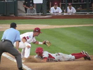 Arkansas runner beats the pick off throw at first base against South Carolina in a 2-1 win at the CWS.
