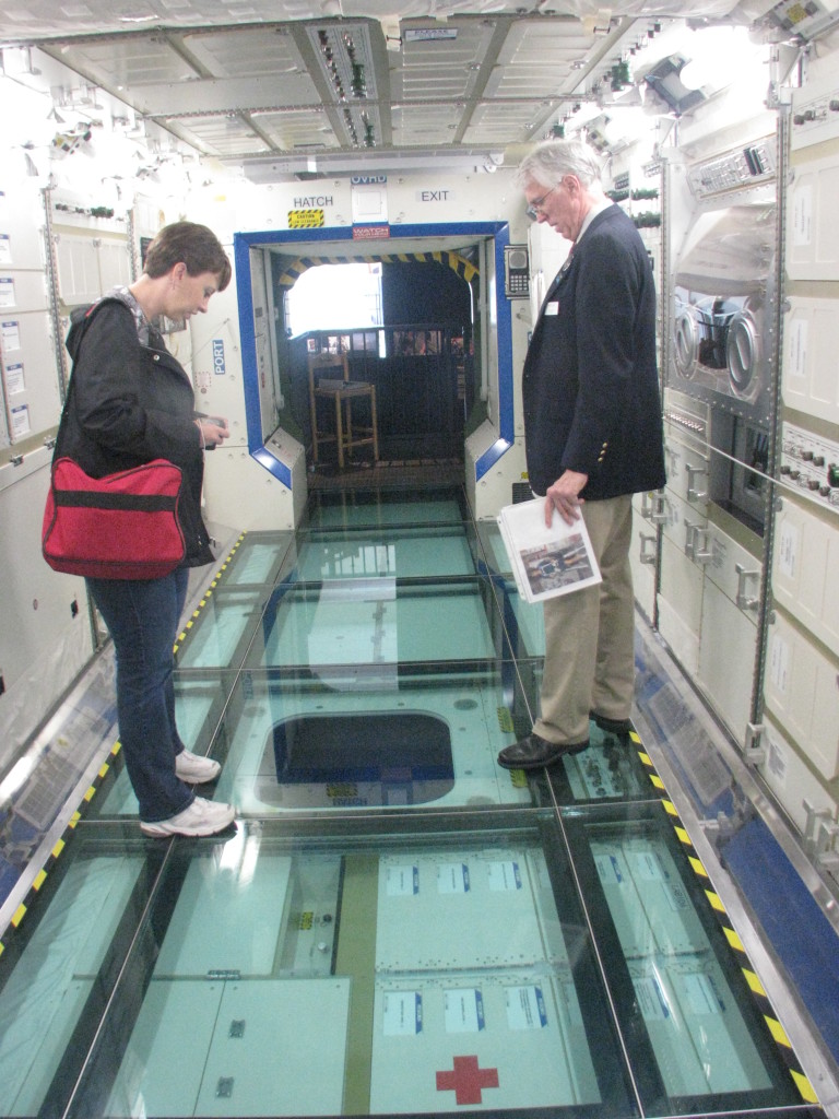 Lisa with a museum docent in the space station lab mock-up.