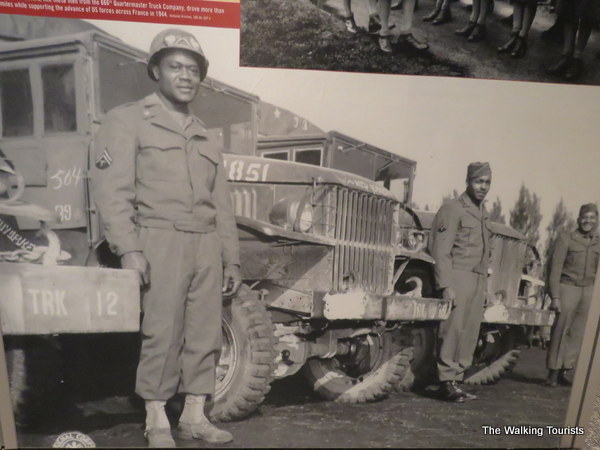 African American soldiers in front of vehicles during World War Two