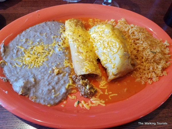 An enchilada and tamale combo lunch special.
