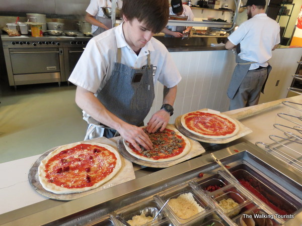 Neapolitan-style pizzas are created by hand by the restaurant's kitchen staff.