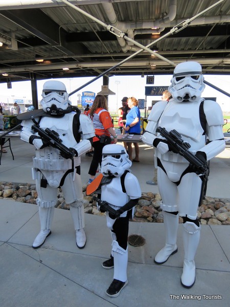 2 adult and one child dressed as storm troopers.