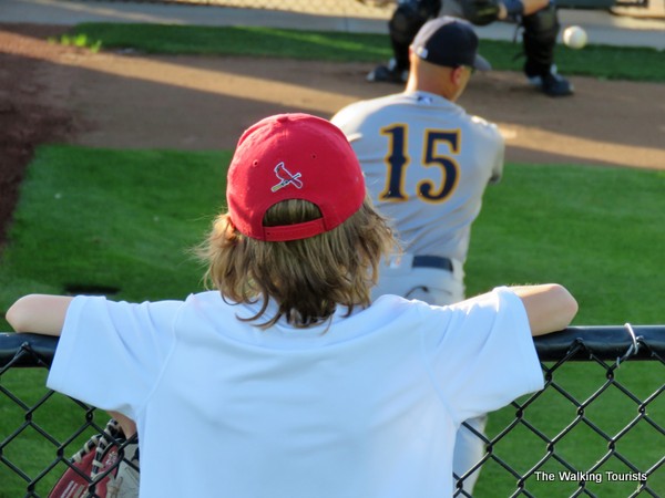 A boy watches a New Orleans pitcher warm up in the bullpen before the game.