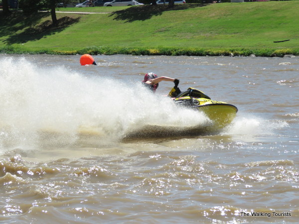 Jet ski racer rounds a buoy on the river.