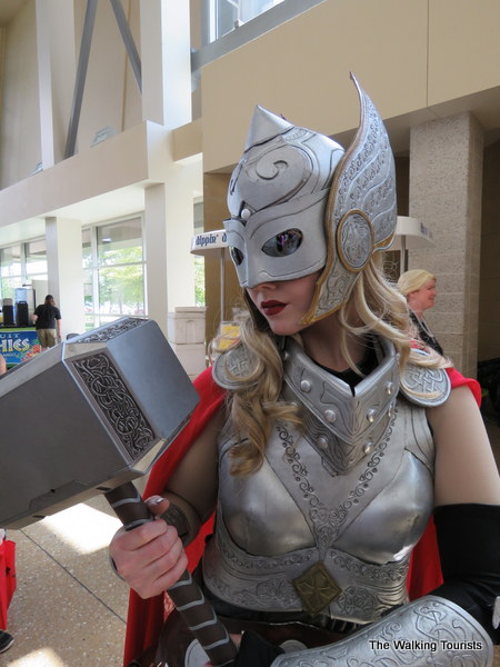 Woman dressed as Thor carrying the hammer