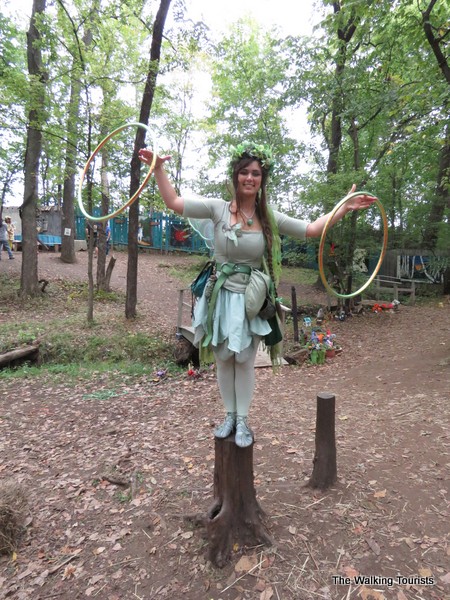 A fairy does her best to entice visitors to wander through the enchanted forest.