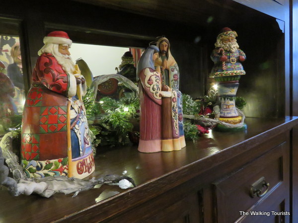 Santa Claus figurines on a cabinet in the dining room.