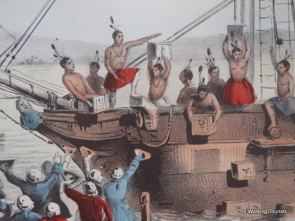 A replica of a painting portrays colonial protestors dressed as Native Americans throwing tea overboard in Boston.