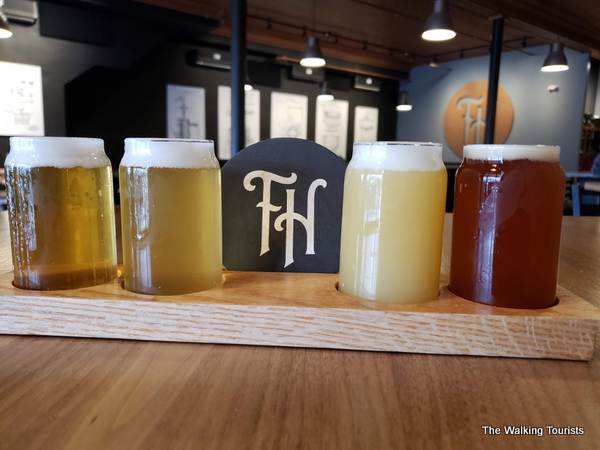 Four beers in small glasses lined up as part of a flight