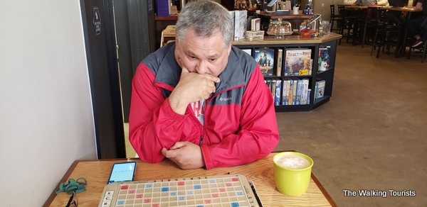 Tim thinks about his next play for Scrabble.