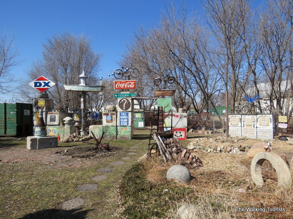 Old gas station signs are among hub caps and store signs attached to concrete blocks in the park