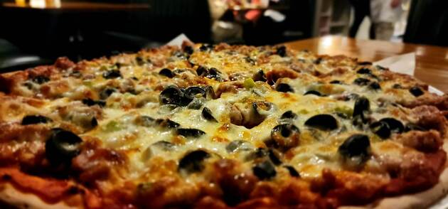 Sausage pizza with black olives.