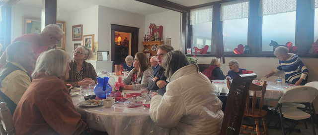 People eating during community meal