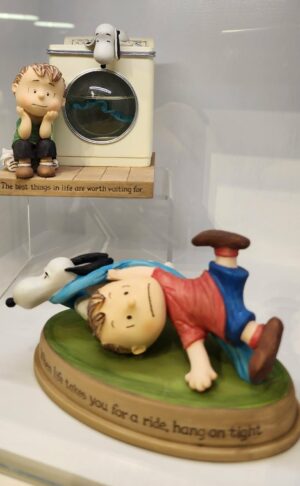 Figurine of Snoopy dragging Linus.