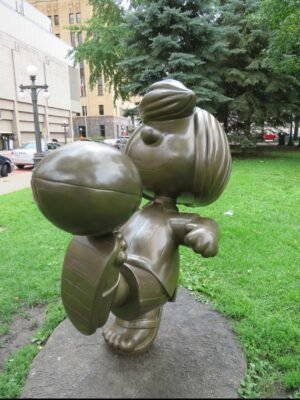 Statue of Peppermint Patty kicking a football
