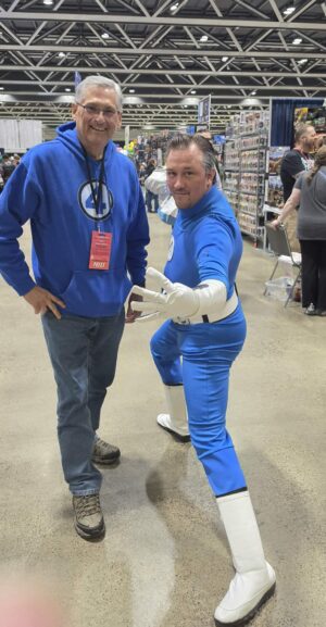 Attendee and character dressed as Reed Richards from Fantastic Four
