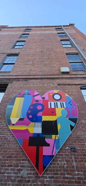 Heart mural attached to side of building.