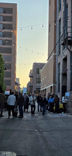 People walking in an alley, taking in the event.