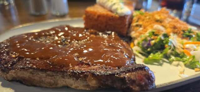 Steak dinner with potato and salad